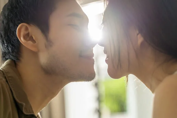 Couple face to face in warm light — HIV Dating When Partners Know Different Things About HIV