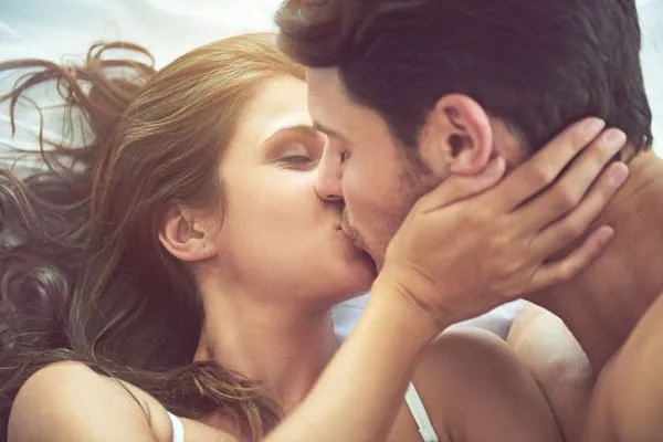 Couple kissing in warm light — HIV Dating When You Want Different Relationship Speeds