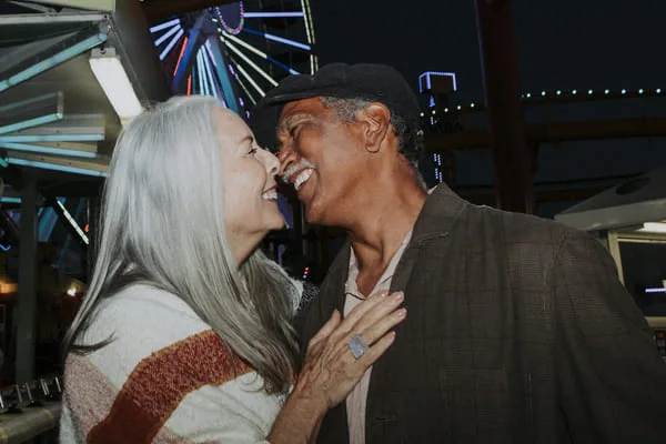 Older couple sharing a kiss — HIV Dating After Widowhood at a Respectful Pace