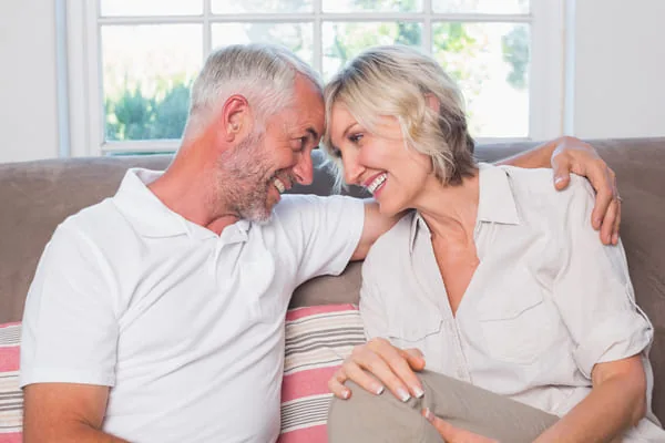 Older couple laughing together — HIV Dating When One Partner Relocates for Love