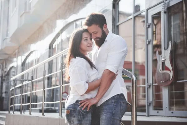 Couple embracing beside a train — HIV Dating Worldwide: Romance Across Distance